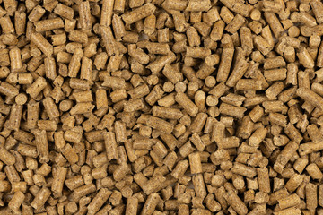 Brown wood pellets texture background. natural pile of wood pellets. organic biofuels. Alternative biofuel from sawdust. The cat litter. pile of compressed wood pellets.
