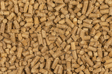 Brown wood pellets texture background. natural pile of wood pellets. organic biofuels. Alternative biofuel from sawdust. The cat litter. pile of compressed wood pellets.