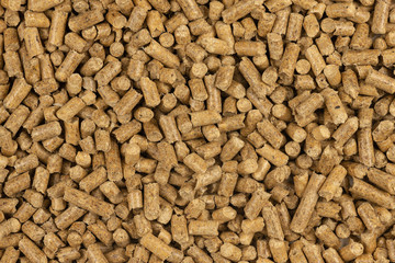 Brown wood pellets texture background. natural pile of wood pellets. organic biofuels. Alternative biofuel from sawdust. The cat litter. pile of compressed wood pellets.