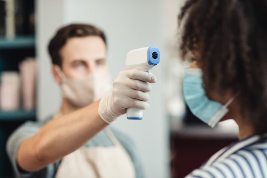 Master checking client with touchless infrared thermometer