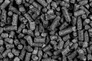 White and black wood pellets texture background. natural pile of wood pellets. organic biofuels. Alternative biofuel from sawdust.
 pile of compressed wood pellets