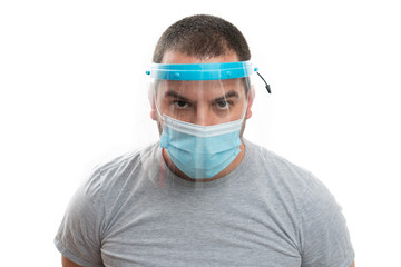 Close-up of adult wearing transparent face shield and medical mask