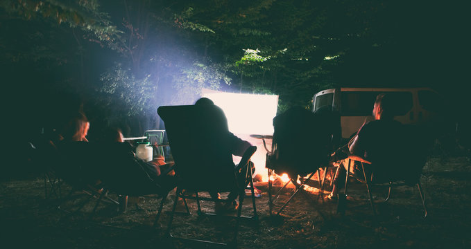 The Friends Are Watching The Movie In The Camp In The Night