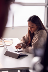 Businesswoman Working From Home Drawing On Digital Tablet Using Stylus Pen