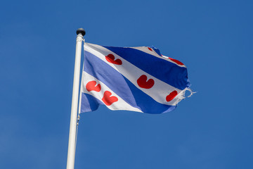 the Friesland flag flaps in the wind on the Afsluitdijk