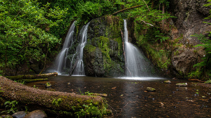 Fototapeta na wymiar Top Falls at Fairy Glen Nature Reserve. A popular woodland walk with two delightful waterfalls, close to the village of Rosemarkie, in the Scottish Highlands