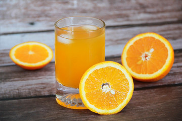 orange drink in a glass and orange slices