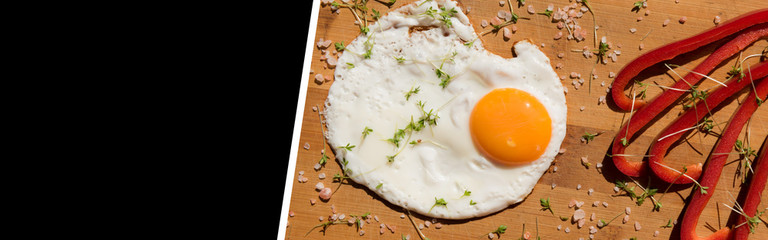 
fried egg on wooden board with space for text