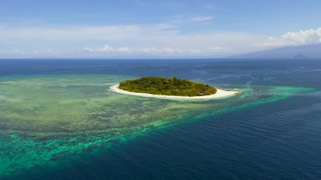 Fly out from a tropical island with white beaches made from white coral sand in the middle of blue ocean,  Mantigue and Camiguin islands, Philippines