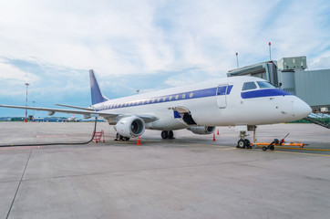 Refueling an aircraft with aviation fuel prior to a commercial flight.