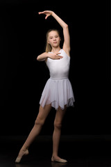 Naklejka premium Full length portrait of a charming gymnast girl in elegant dress.