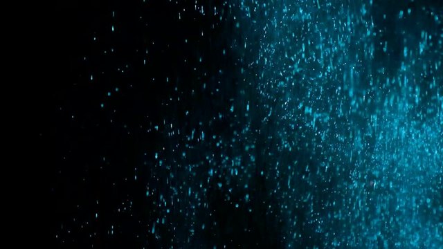 blue sequins. Bright sequins.Bright Explosion Glitter with Flickering. Colourful Elegant Confetti Burst on Black Background. Slow Motion