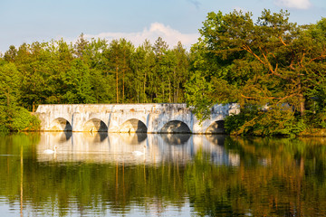 Fototapeta na wymiar Old stone bridge over Vitek pond, Nova Hlina near Trebon, Jindrichuv Hradec district, Southern Bohemian, Czech Republic