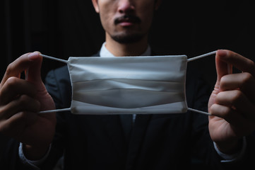 Businessman in suit wearing a face mask, People pay attention to the virus alerts coming from contact