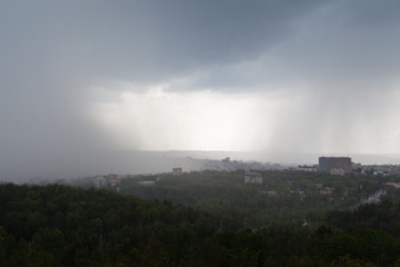Obraz na płótnie Canvas Dark cloud pouring rain over the city