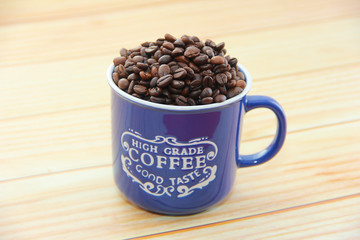 natural black coffee beans and ceramic blue a mug