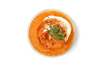 Bowl of pumpkin puree with parsley isolated on white background