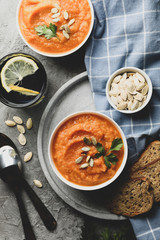 Composition with pumpkin soup on gray background, top view