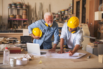 Two architects working on a blueprint