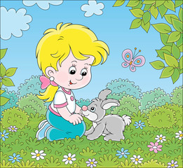 Smiling little girl playing with her small grey bunny among flowers on green grass on a summer day, vector cartoon illustration