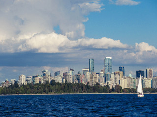 Fototapeta premium Sailboat and Vancouver skyline seen from the sea on a beautiful summer day.