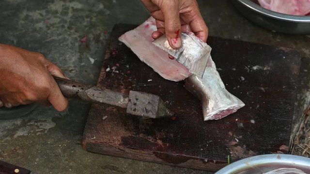Fishermen are cutting fish for cooking.