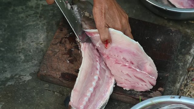 Fishermen are cutting fish for cooking.