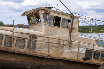 Old abandoned boat on the river. Old passenger boat.