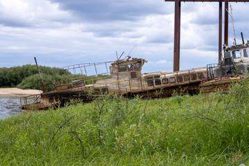 Fototapeta na wymiar Old abandoned boat on the river. Old passenger boat.