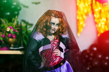 Happy Halloween. Cute little girl dressed in halloween costum with  decoration at the halloween party.
