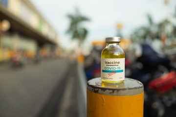 A single bottle vial of Covid-19 coronavirus vaccine in public. The coronavirus is expected to end. Hope, healthcare, medical concept.