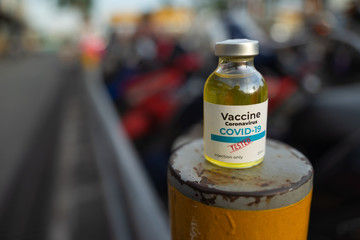 A single bottle vial of Covid-19 coronavirus vaccine in public. The coronavirus is expected to end. Hope, healthcare, medical concept.