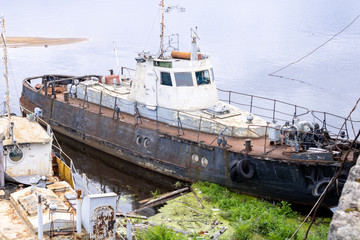 Old abandoned boat on the river. Old passenger boat.
