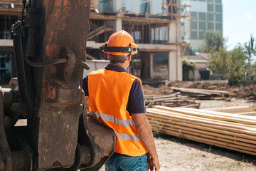 Back view of the engineer in worker helmet