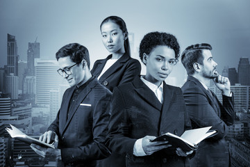 Group of four business colleagues in suits working on project together to gain new career...