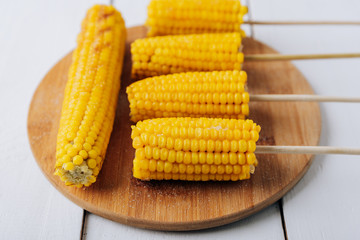 Boiled corn on a white wooden natural background