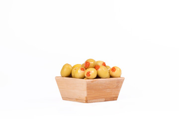 Green olives in wooden bowl isolated