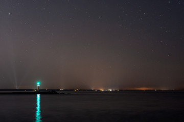 Lighthouse in the sunset and the moon rise