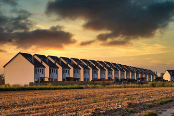Row terrace house in sunset on new housing estate