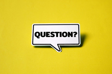Blank speech bubble on white paper isolated on yellow paper background with drop shadow.