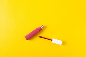 female bright lipsticks on mono colour yellow background