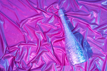 Iridescent neon background. Holographic Abstract pastel colors backdrop with Champagne bottle. Hologram Foil Aesthetic. Trendy vaporwave creative party concept.