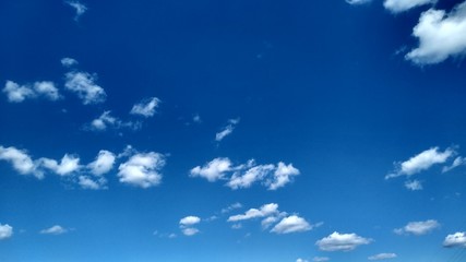 Naklejka na ściany i meble Blue sky with white clouds. Peaceful sky background. Space for text.
