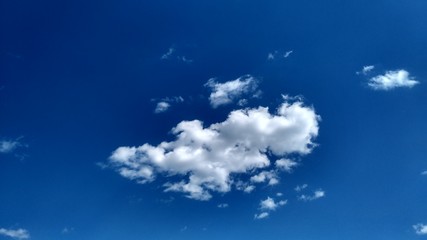 Naklejka na ściany i meble Blue sky with white clouds. Peaceful sky background. Space for text.