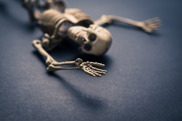 Skeleton lay on space of the dark floor is looking and wave the hand,  selected focus at end of the...