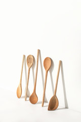 Kitchen utensils casting a strong shadow on a white wall, minimalist contemporary home kitchen decor concept