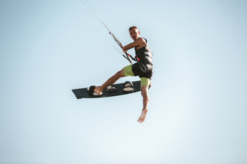 Kitesurfing Kiteboarding action photos man among waves quickly goes