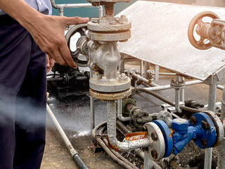 Engineer is shutting down or servicing a leaking valve.