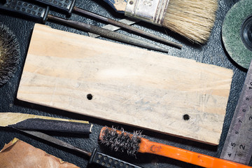 Blank old pine wood around with rub brush and rasp tools on working table use as background
