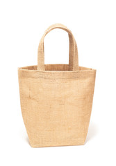Brown handbag made from natural burlap or cotton fibre is woven isolated on white background